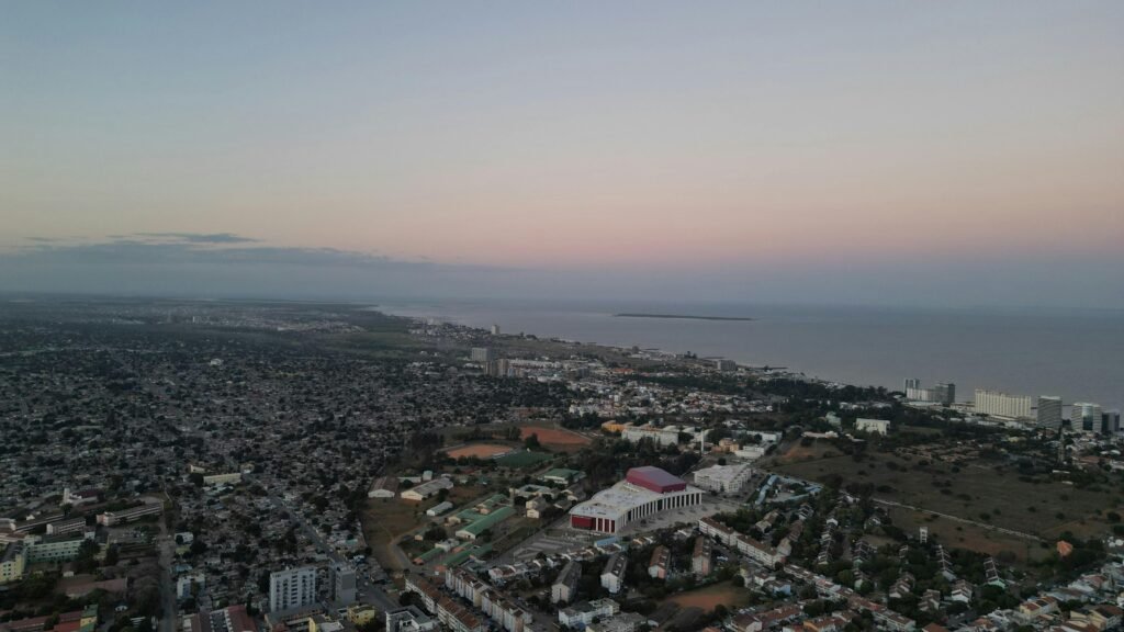 Stunning aerial view of Maputo, Mozambique during twilight, showcasing the cityscape and coastline.